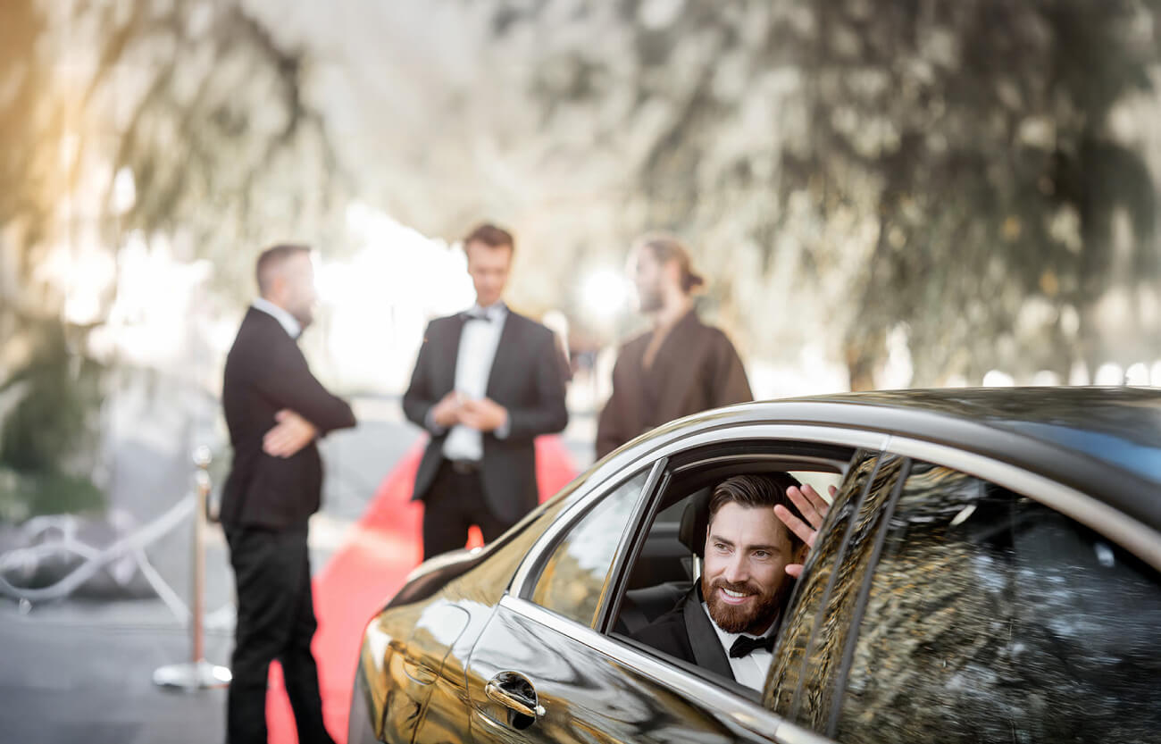 Corporate guests arriving by chauffeured vehicle